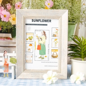 Vintage wooden photo frame with sunflower illustration and rustic white finish on desk