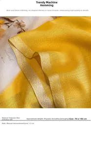 Close-up of yellow faux silk scarf featuring golden metallic edge stitching and fine texture