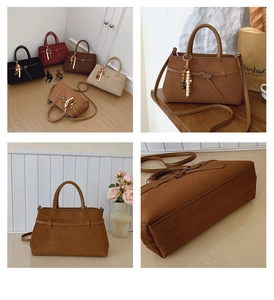 Detailed view of vintage matte leather tote bag featuring elegant bead pendant and strap
