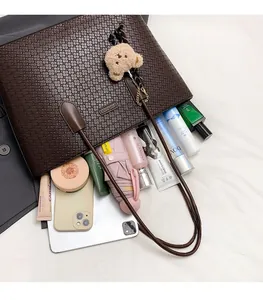 Deep brown woven tote bag interior showing large capacity for tablet and cosmetics