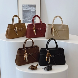 Vintage matte leather tote bag for women available in five colors with ethnic bead pendant