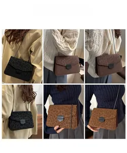 Detailed view of leopard print crossbody bag with metallic chain strap and secure buckle
