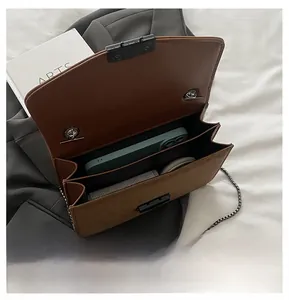 Detail view of the leopard print crossbody bag showing dual interior compartments and storage