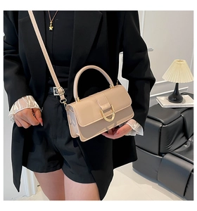 Detail of light beige PU leather mini bag with gold D-buckle and adjustable strap