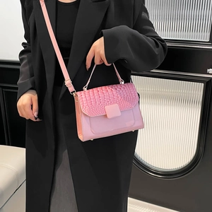 Pink crocodile-embossed leather flap handbag with gold-tone hardware and crossbody strap