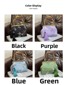 Detail showing vintage bamboo handles and embroidered floral patterns on satin handbags