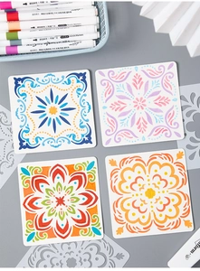 Macro shot of 4 different mandala floral PET stencils with colorful painted DIY results