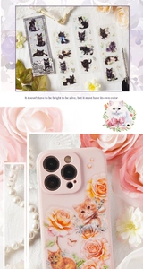Detail of cat and flower stickers applied on a pink phone case with vintage floral props