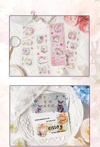 Macro shot of cute Muppet Snowball cat stickers with decorative vintage art cards