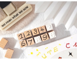 Macro detail of decorative wooden bear stamps with numbers for creative DIY journaling