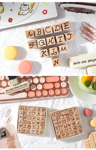 Detail of wooden alphabet stamps featuring cute cat designs in a vintage desktop setting