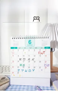 Detailed view of a 2025 minimalist vertical coil calendar on a blue checkered tablecloth