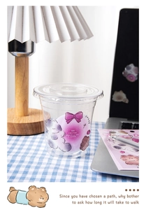 Close-up of DIY starry stickers with cartoon cats on a clear plastic cold drink cup