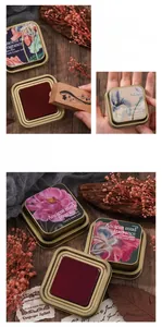 Macro shot of large metal tin ink pad with floral pattern for vintage scrapbooking art