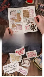 Detail of vintage ink pad set with butterfly and botanical stickers for DIY journaling