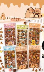 Close-up of cute guinea pig PET stickers with various themes on a warm wooden desk