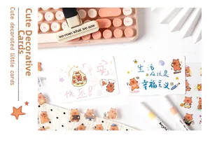Detail of cute bear stationery set including decorative cards and stickers on a keyboard