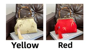 Detail of red and yellow silk bags featuring bamboo handles and leaf embroidery
