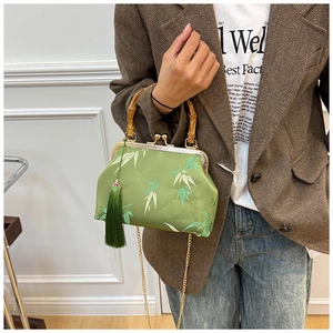 Detail of bamboo joint handle and green leaf pattern on a retro cheongsam handbag