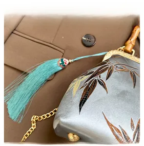 Macro detail of Chinese bamboo embroidery, bamboo handle, and elegant tassel charm