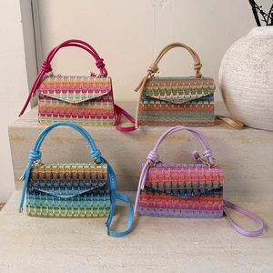 Colorful woven crossbody handbag with geometric patterns and knotted handles for summer