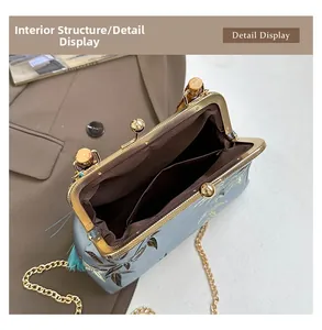 Internal view of light blue satin evening bag showing inner pocket and gold chain strap