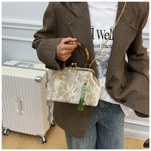 Detailed view of bamboo handle and velvet bag with elegant white bamboo leaf pattern