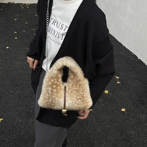 Plush bucket bag with faux fur deer print, gold metal ball detail, and chain strap