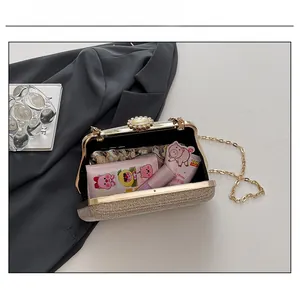 Internal view of the gold sequin clutch bag showing capacity for lipstick and cards