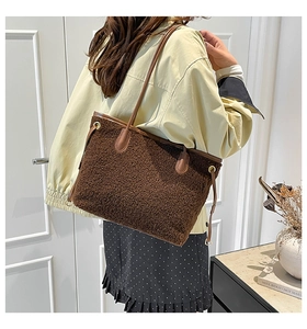 Detail of plush brown tote bag featuring lamb-like faux fur texture and leather straps