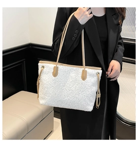 Furry white tote bag with brown leather straps shown on a model for autumn style
