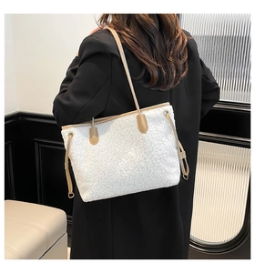 Detail of white faux fur tote bag with brown leather straps and side drawstring design