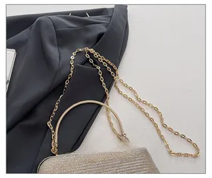 Detailed macro view of the glossy gold chain strap and shimmering rhinestone surface