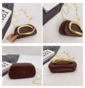 Detail view of dark brown woven box bag with golden metal handle and chain strap