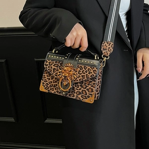Leopard print crossbody bag with gold lion head hardware and studded leather trim