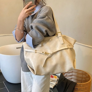 Minimalist beige oversized tote bag in litchi textured leather for daily commuting