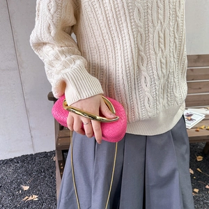 Fuchsia woven clutch bag with gold metallic handle and crossbody chain for women