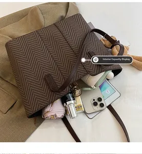 Large capacity herringbone tote bag showing interior space for laptop and daily essentials