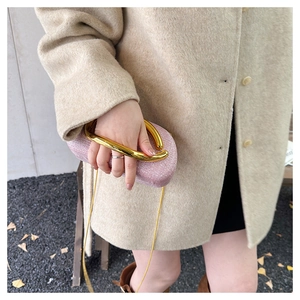 Pink glitter clutch bag with elegant gold U-shaped metal handle and chain strap