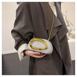 Detail view of sparkly silver evening bag with a designer gold ring clasp and metal chain