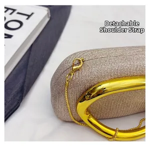 Detail of glitter fabric texture with polished gold U-handle and detachable chain