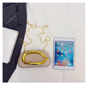 Top view of champagne gold sequin evening clutch with metal handle and chain strap
