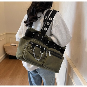 Close-up of military green corduroy tote bag featuring punk rivets and chain details
