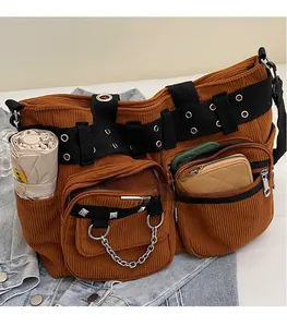 Detail view of brown corduroy crossbody bag showing multi-pockets and large storage capacity