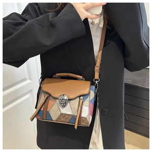 Detail of vintage patchwork crossbody bag featuring multi-texture leather and silver clasp