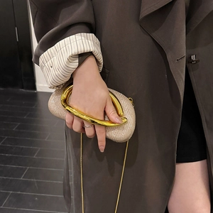 Sparkling champagne gold evening clutch with chunky metal handle and chain strap