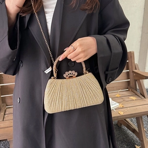 Elegant gold pleated evening bag with rhinestone crown buckle and stylish chain strap