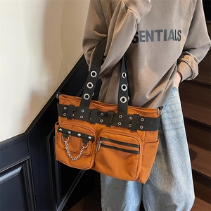 Brown corduroy tote bag with punk rivets and metal chain shown on a casual model