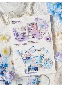 Close-up of Mori girl style stickers used for DIY journaling on a grid notebook