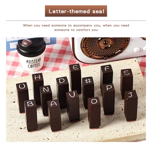 Macro detail of wooden alphabet stamps with vintage lettering and red rubber pads